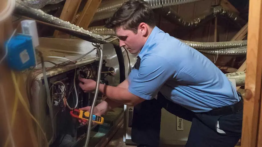 Aire Serv technician fixing heater