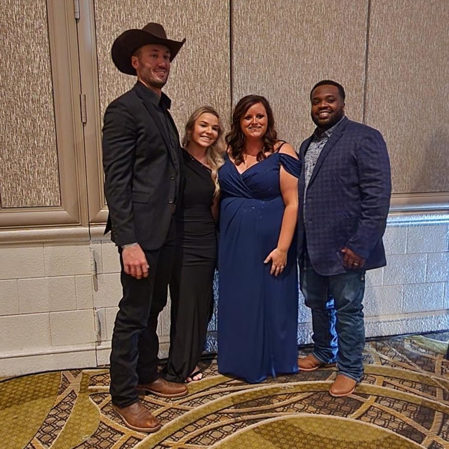 4 people standing together for photo shoot