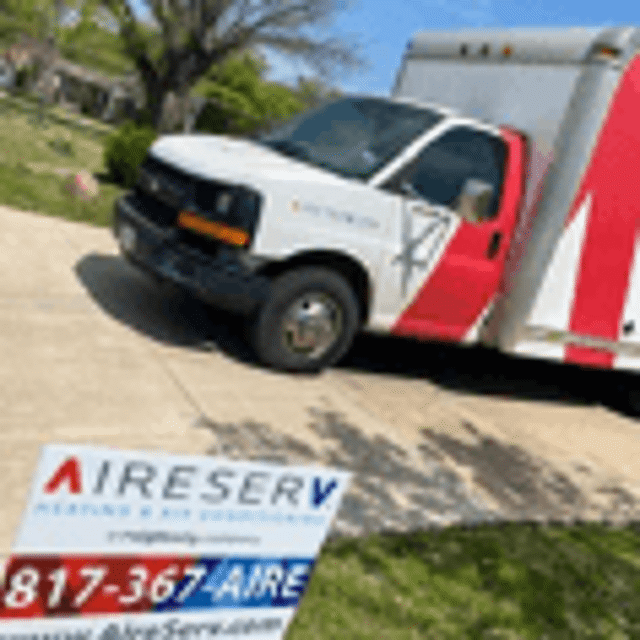 Aire Serv truck parked near Aire Serv sign