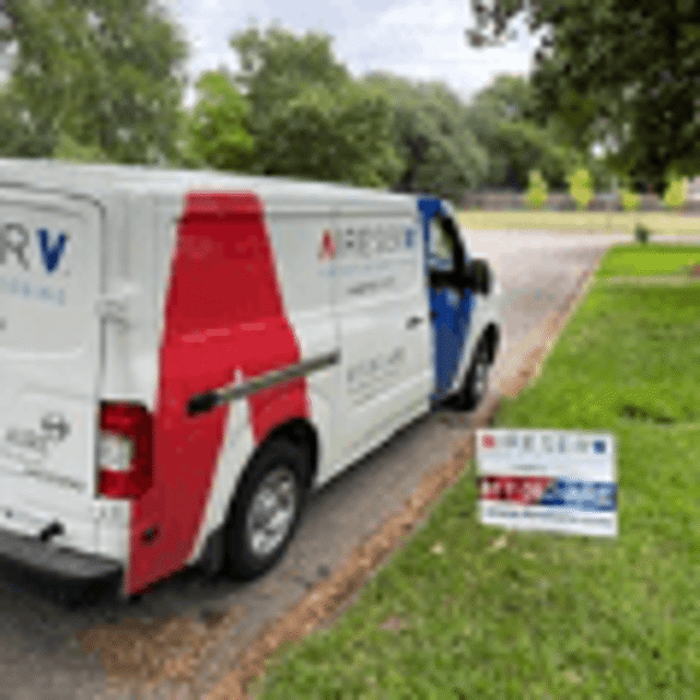 Aire Serv van and Aire Serv sign right next to each other