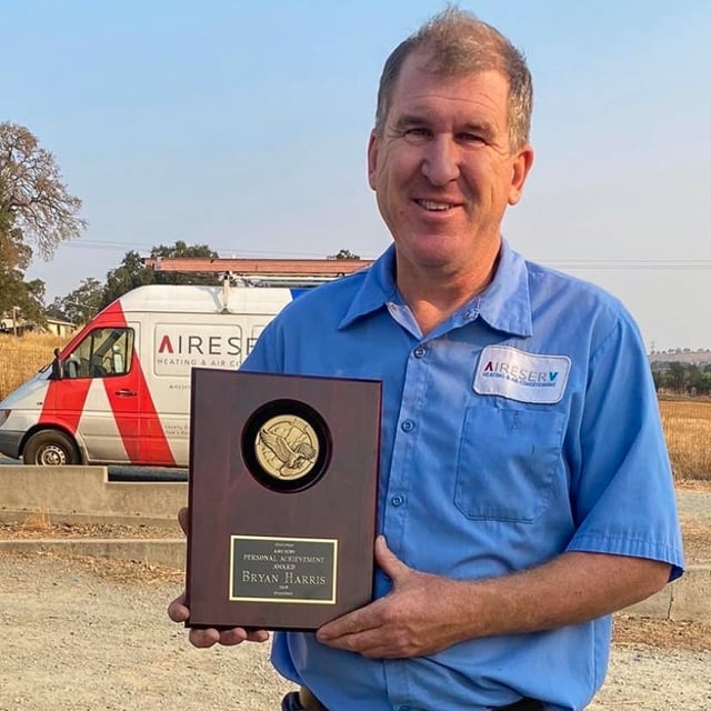 Bryan Harris holding the Personal Achievement Award