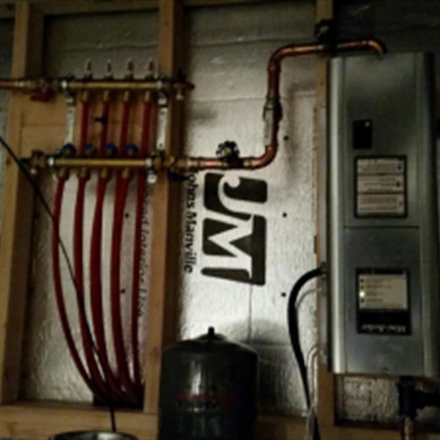 Electric boiler installed in a crawl space for garage radiant floor heat.