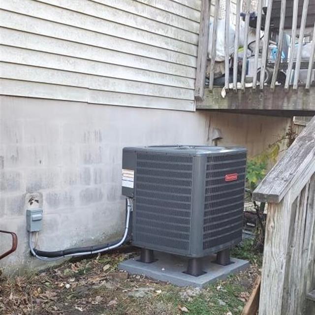 A Goodman AC unit installed outside a home