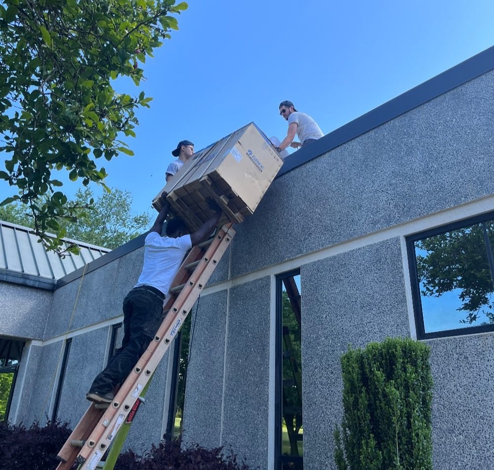 Aire Serv Team Installing a Unit on a Low Roof