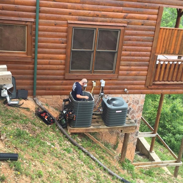 Tech working on A/C Condenser