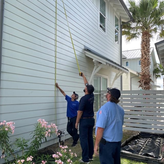 Three Aire Serv Technicians Working Outside