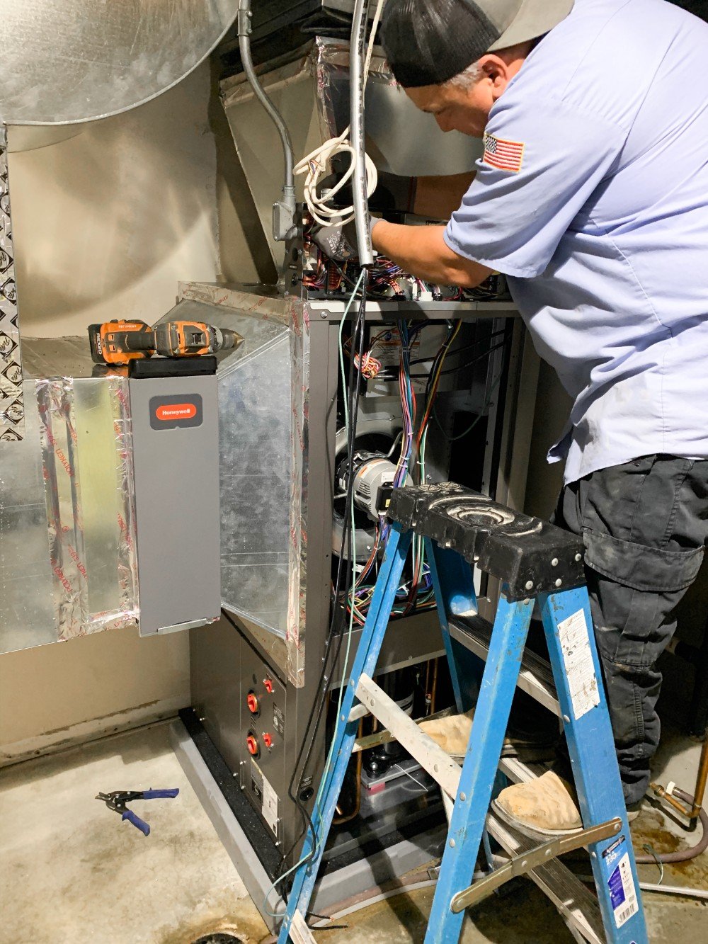 Technician working on a furnace checking to make sure everything is working as it should.