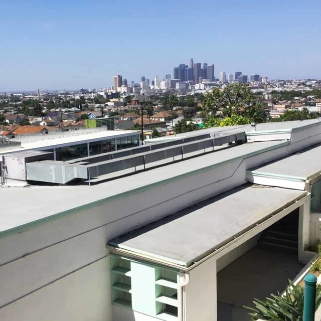 View of the Los Angeles skyline from a rooftop.