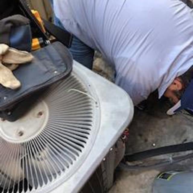 man working on ac unit