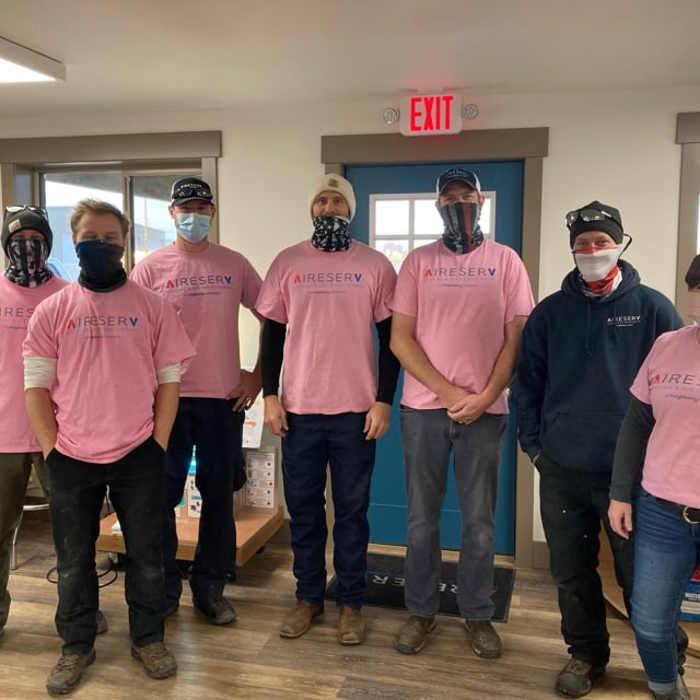 team photo in pink shirts