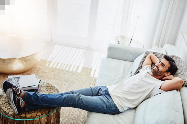 Shot of a man relaxing on the sofa at home | Aire Serv® of Springfield, IL