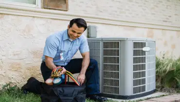 An Aire Serv service professional helps a homeowner troubleshoot their HVAC system.