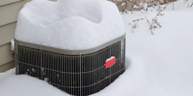 AC unit covered with snow | Aire Serv