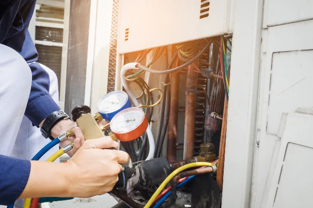 Technician servicing AC unit