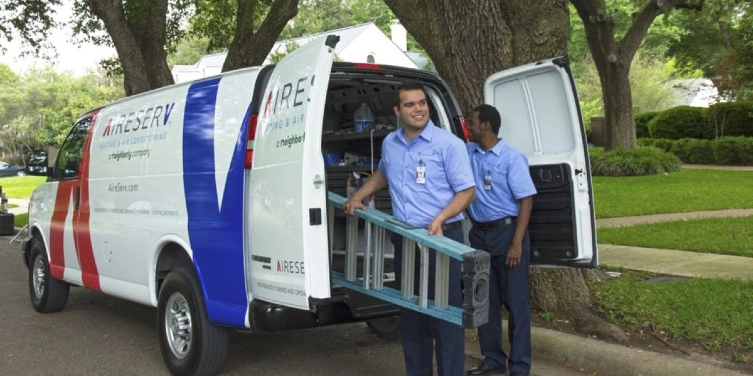 Aire Serv service professionals taking ladder and tools from truck to provide HVAC service for residential home