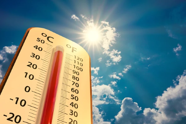 A thermometer in the foreground displays a temperature of over 100 degrees Fahrenheit as the sun blazes down. | Aire Serv of Citrus County