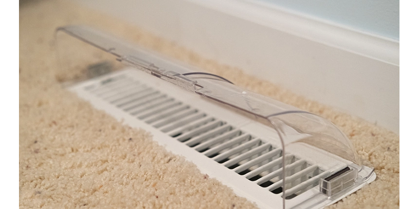 Close-up of floor air vent with plastic diverter.