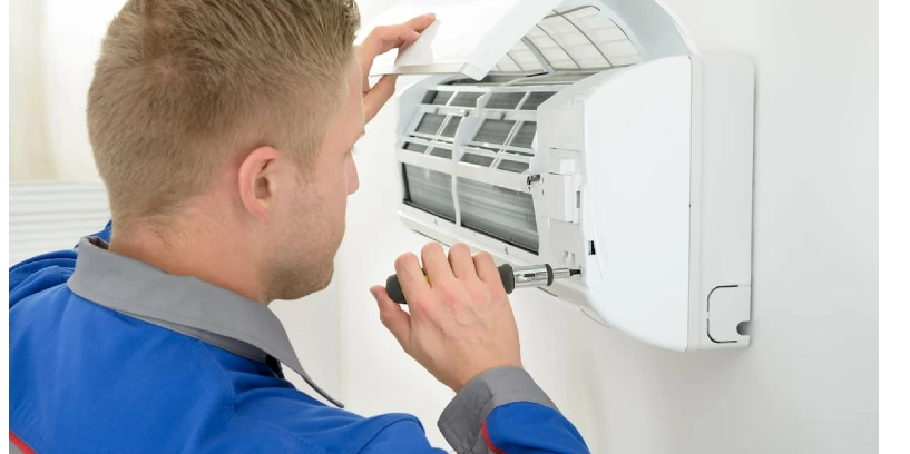 AC Technician fixing AC unit