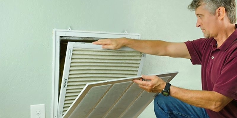 Man replacing air filter