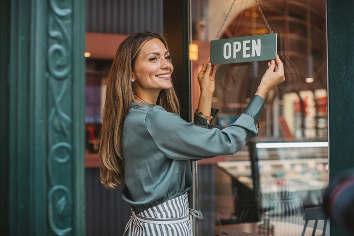 Young woman owner opening her store | Aire Serv of Birmingham