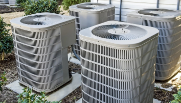 Group of new AC units outside a residential home.