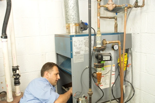 Technician checking a gas furnace