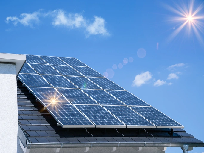 The sun beats down on a set of solar panels installed on the roof of a home. | Aire Serv of Citrus County