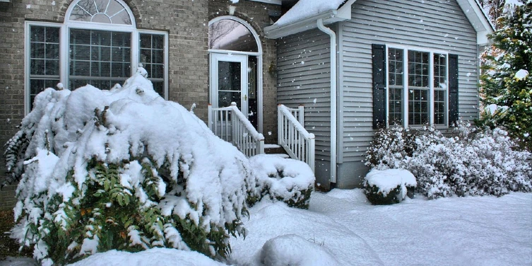 House during a snow storm with snow on the ground