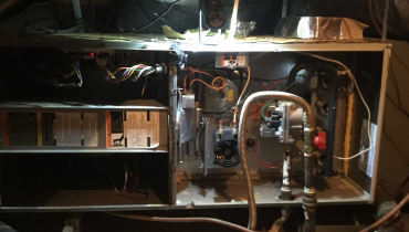 An interior view of a residential furnace in Dallas as it is being serviced with an annual furnace tune up.