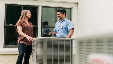 Aire Serv service professional speaking with homeowner about the HVAC refrigerant mandate