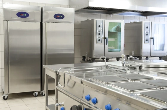 An empty commercial kitchen with two large refrigerators in the background. | Aire Serv of Western North Carolina