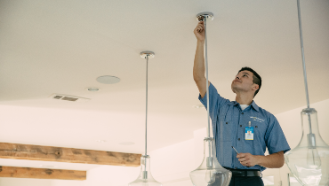 Man working on hanging light