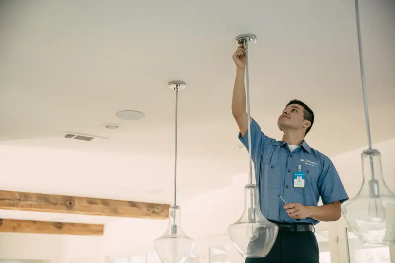 Man working on hanging light