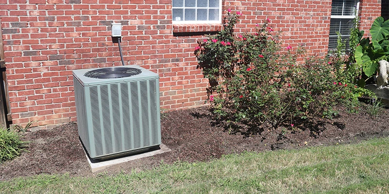 AC condenser unit outside brick house