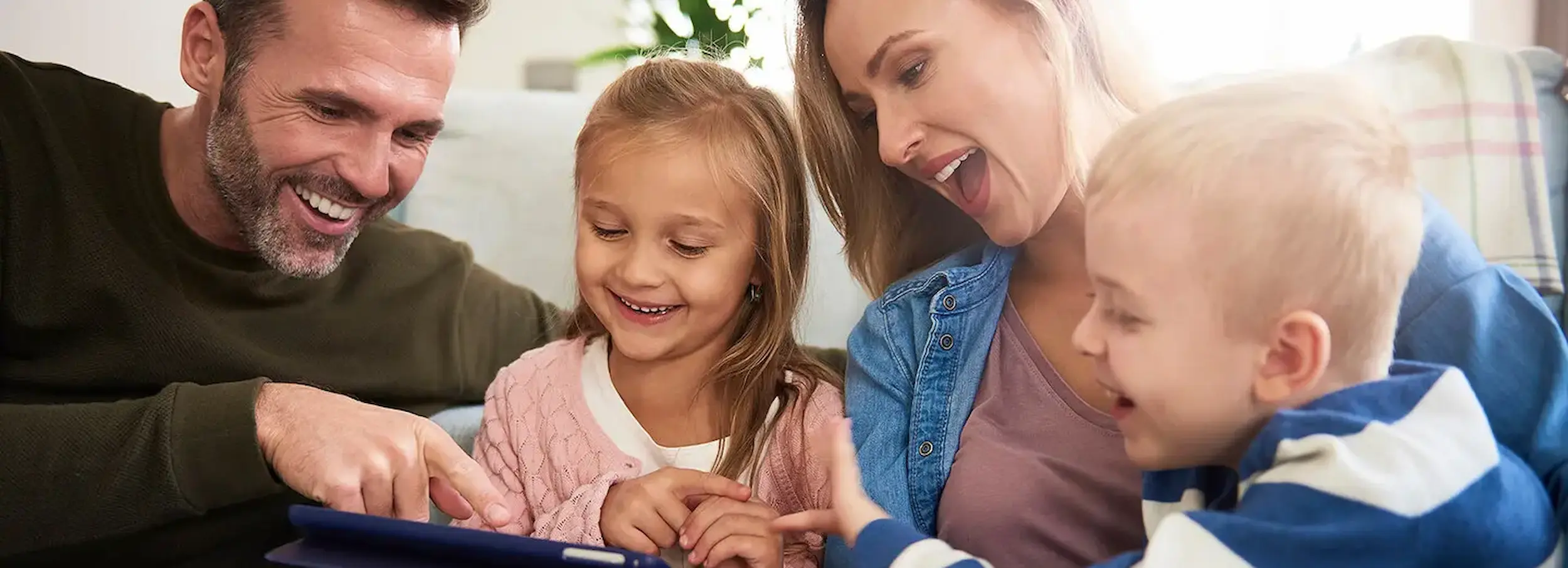 A happy family viewing a tablet.