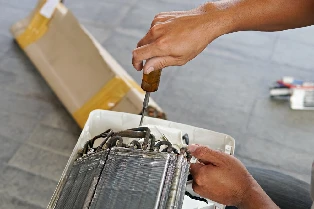 Technician repairing broken AC unit