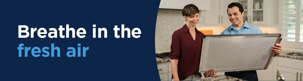  The text “Breathe in the fresh air” next to an image of an Aire Serv service professional showing an air purifier filter to a female customer.