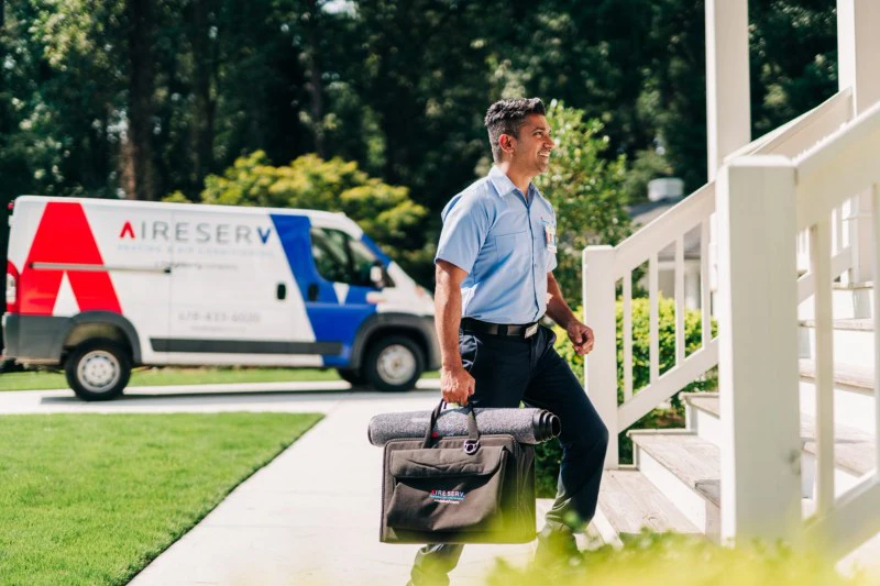 Aire Serv tech walking to customer's home to provide heating & air conditioning services