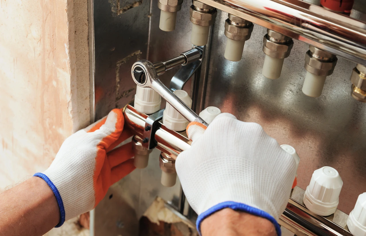 Close-up of HVAC technician completing heater repair service.