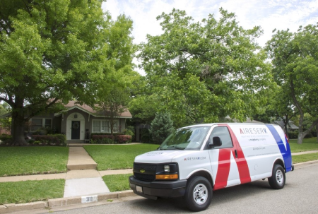 Aire Serv branded van parked outside of residential home.