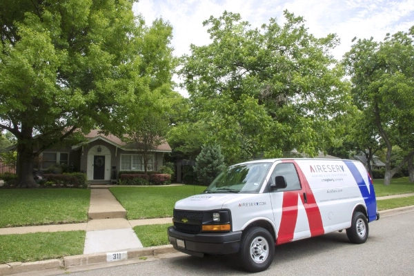 A white work van from Aire Serv parked outside of a home where services are being provided for HVAC in Wexford, PA.